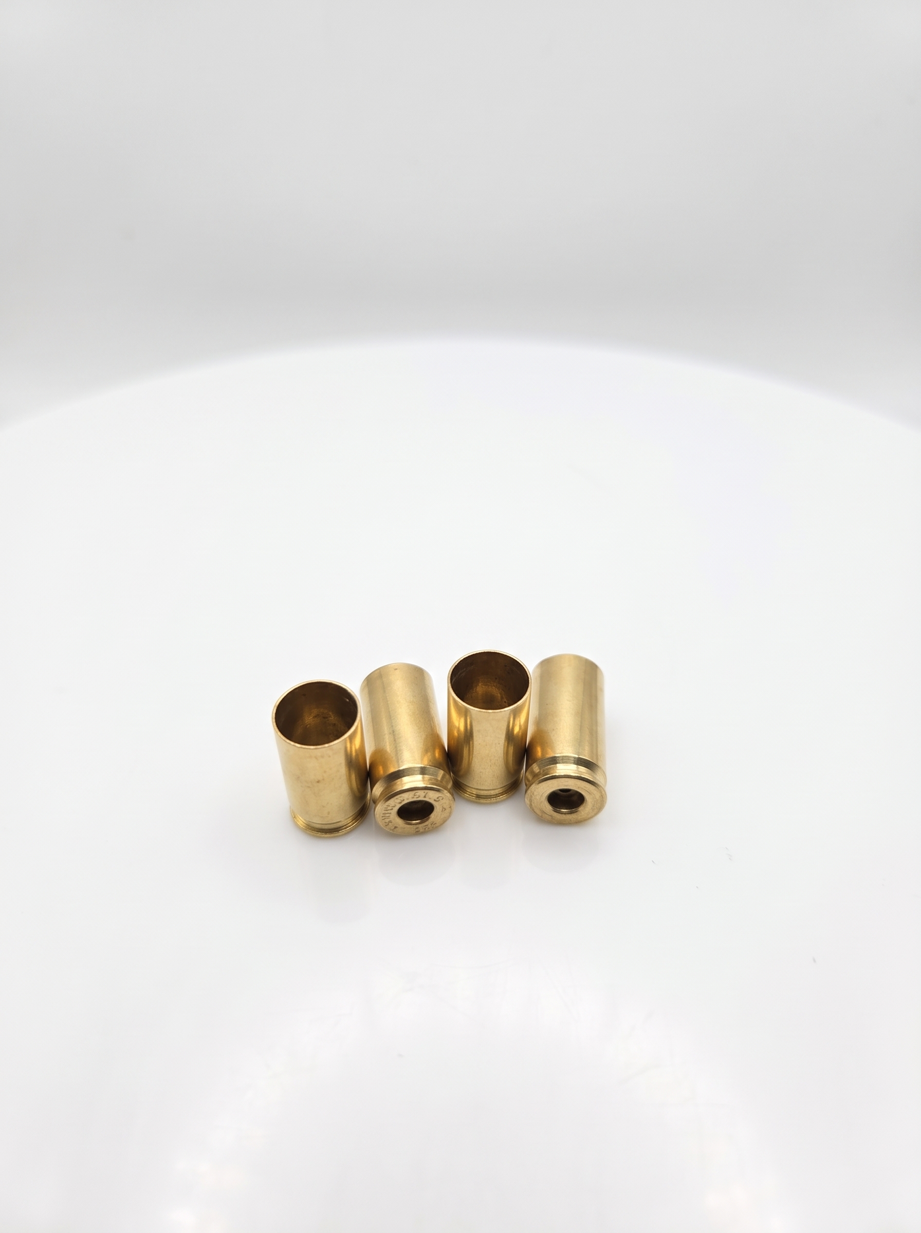 Ready-to-prime: Single Headstamp Processed 9mm Luger brass cases hand-sorted, and polished on a white background.